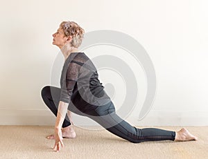 Older woman in yoga lunge position