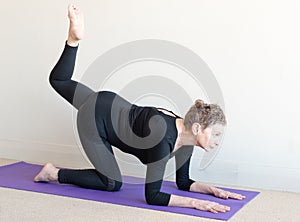 Older woman in yoga pose on elbows