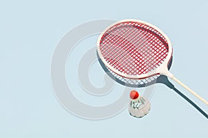 Oldschool racket and birdie on blue background photo