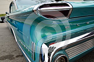 Oldsmobile in Blue - shiny chrome rear quater color photo
