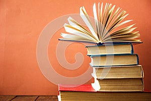 OldStack of colorful books. Education background. Back to school. Book, hardback colorful books on wooden table. Education busines