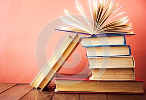 OldStack of colorful books. Education background. Back to school. Book, hardback colorful books on wooden table. Education busines