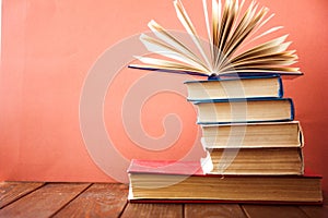 OldStack of colorful books. Education background. Back to school. Book, hardback colorful books on wooden table. Education busines