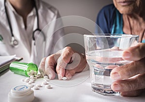 Oldster taking daily medication dose at home