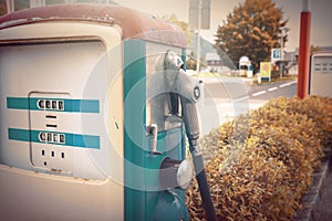 Oldtime or vintage Red white blue color fuel gasoline station box and dispenser in blur Europe background. S