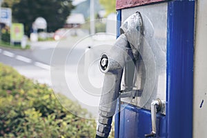 Oldtime or vintage Red white blue color fuel gasoline station box and dispenser in blur Europe background. S