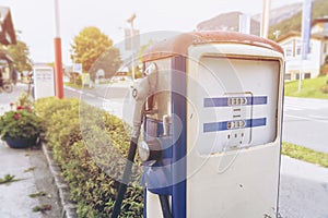 Oldtime or vintage Red white blue color fuel gasoline station box and dispenser in blur Europe background. S photo