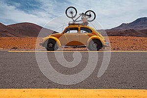 Oldtimer beetle car on the road in the desert