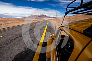 Oldtimer beetle on the road in a desert landscape