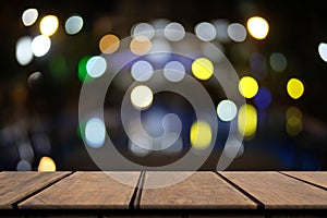 Ole empty wooden table of brown on front blurred night colorful