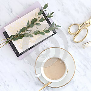 Olive branch on a card with cup of coffee and gold scissors