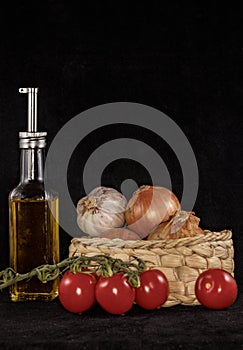 Olive oil and other nutricious ingredients against a black background photo
