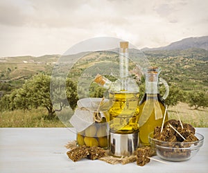Olive oil and black bread over trees of olives background