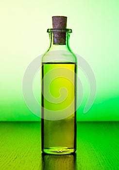 Olive oil bottle on green light tint