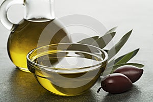 Olive oil in bottle with olives