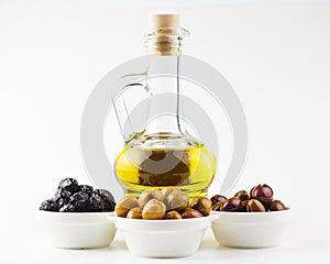 Olive oil bottle and olives in bowls