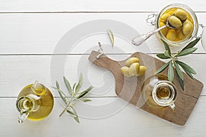 Olive oil bottle with olives and olive branch