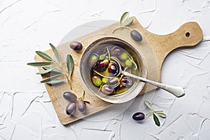 Olive oil in bowl with fresh olives
