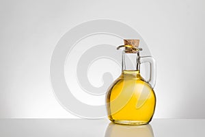 Olive oil container bottle with stopper on grey gradient background