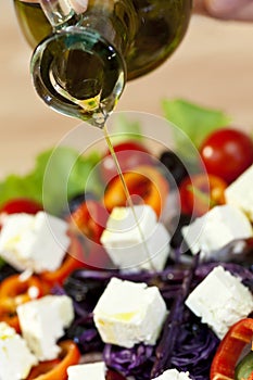 Olive Oil Dressing Pouring Onto Fresh Salad