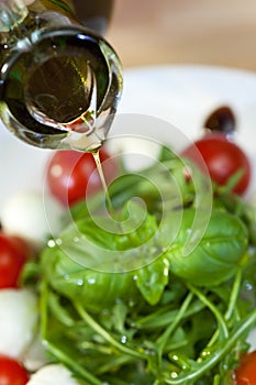 Olive Oil Dressing Pouring Onto Fresh Salad