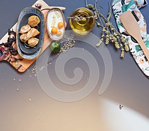 Olive oil, dried herbs, Physalis on table