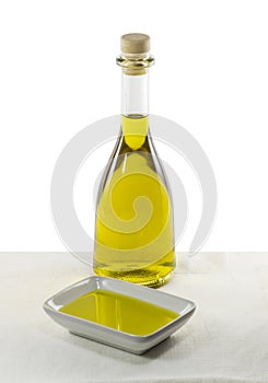 Olive oil in glass bottle and dish