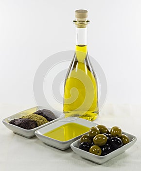Olive oil in glass bottle and dished products