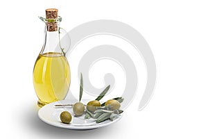 Olive oil in a glass bottle and olives in a white ceramic plate