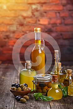 Olive oil in glass bottles and olives