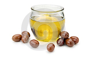 Olive oil in a glass bowl with olives