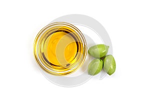 Olive oil. Greek olive oil in glass transparent bowl with three green olives. Close-up, Isolated on white background