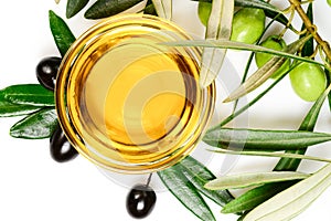 Olive oil. Greek olive oil in square glass transparent bowl with fresh and marinated olives and leaves. Close-up, Isolated on