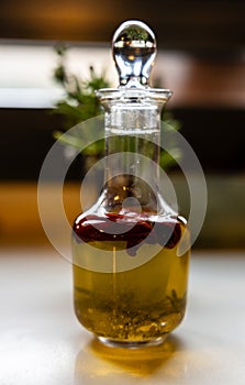Olive oil and herbs in glass cruet