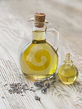 Olive oil and lavender on a wooden kitchen table.