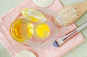 Olive oil, lemon slice, egg yolk, wooden hairbrush and make-up brush. Natural skin and hair care, homemade spa and beauty