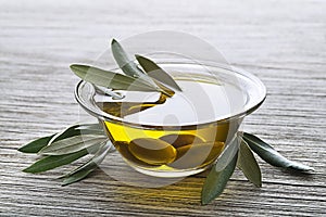 Olive oil with olives and branch