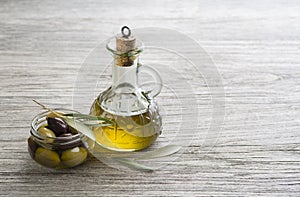 Olive oil with olives and branch