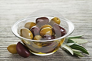 Olive oil with olives fruit in glass bowl