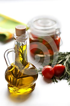 Olive oil with rosemary and cherry tomatoes.