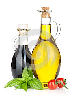 Olive oil, vinegar bottles with basil and tomatoes