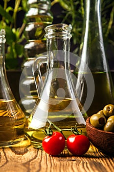 Olive oils in bottles with ingriedients