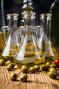 Olive oils in bottles with ingriedients