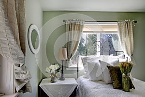 Olive tones bedroom with antique iron frame bed