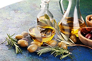 Olives. Bottle virgin olive oil and oil in a bowl with some green and black olives