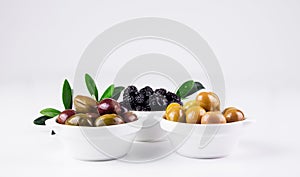 Olives in bowls on white.