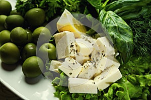 Olives, brynza and greens on a plate,Fresh salad with bryndza, o