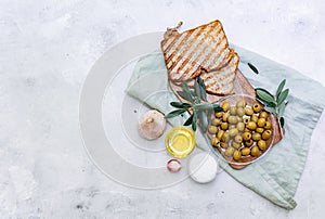 Olives and fresh bread on a table,