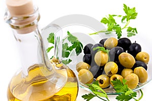 Olives and oil jug with greens