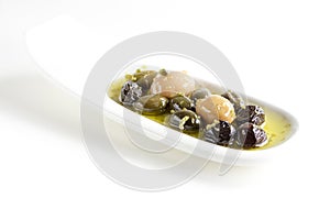 Olives, oil and spice on white plate